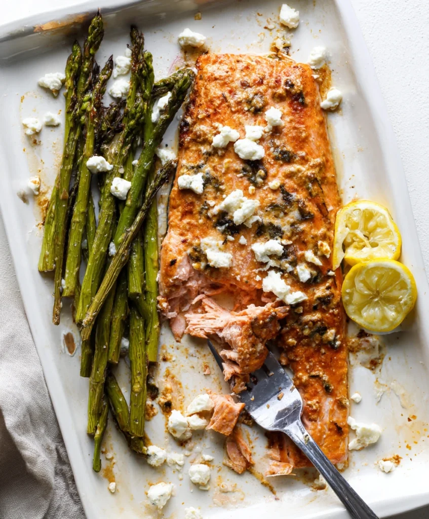 Effortless Sheet Pan Mediterranean Salmon (Flavor-Packed & So Easy!) 3 A healthy and delicious plated serving of Sheet Pan Mediterranean Salmon with flaky fish, tender asparagus, lemon, and feta.